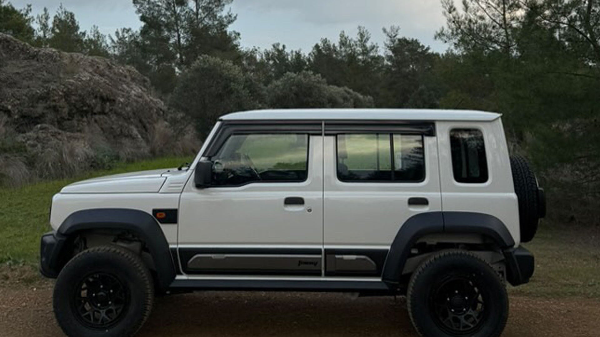 white Suzuki Jimny 5-door Fitted with Magpie M-01 Wheels and Various Accessories