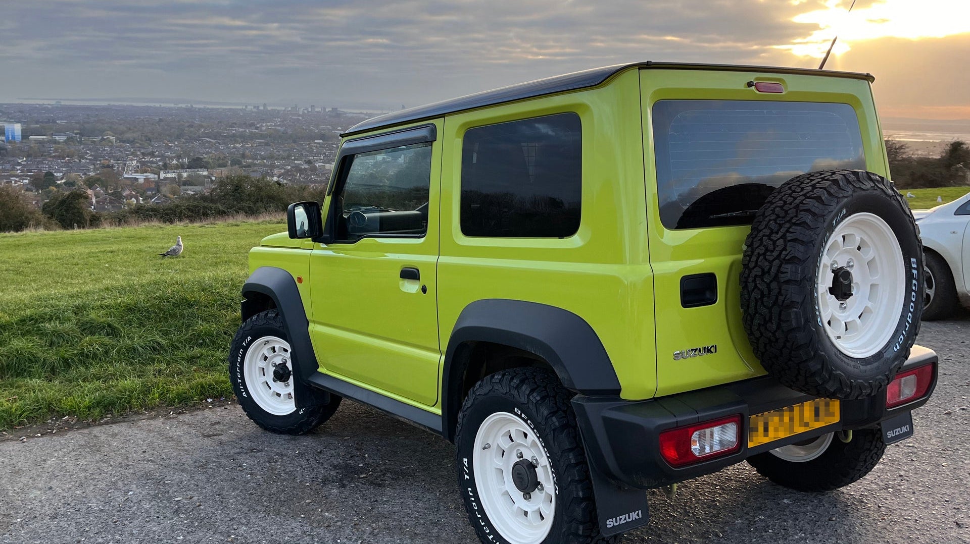 Green Suzuki Jimny with white High Peak J-01 wheels