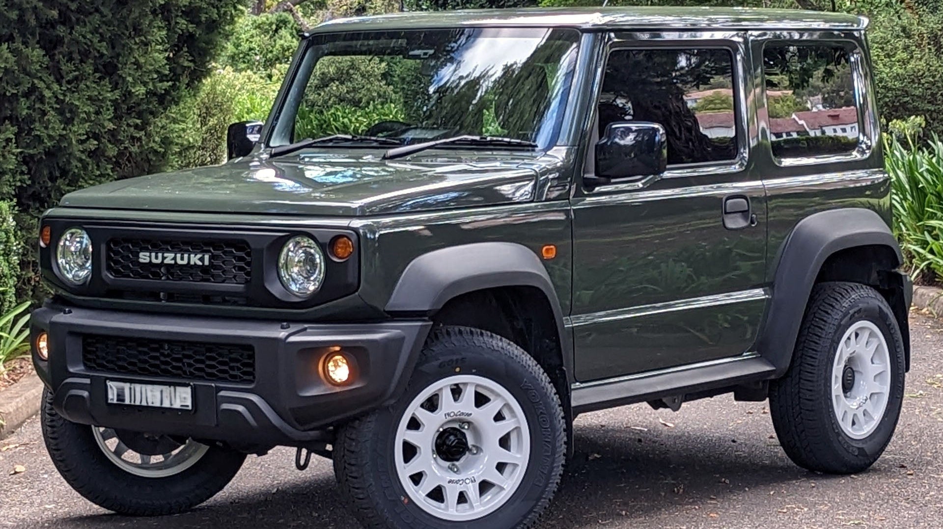 Jungle Green Suzuki Jimny (2018+) fitted with white EVO Corse DakarZero wheels