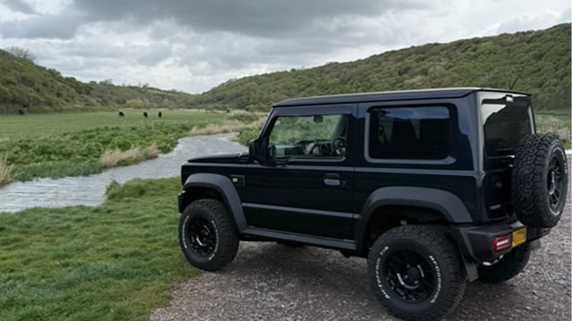 Black Suzuki Jimny 2018+ fitted with Retro Grille and Tactical Grill badge as well as various JIMNYSTYLE LED Lighting accessories