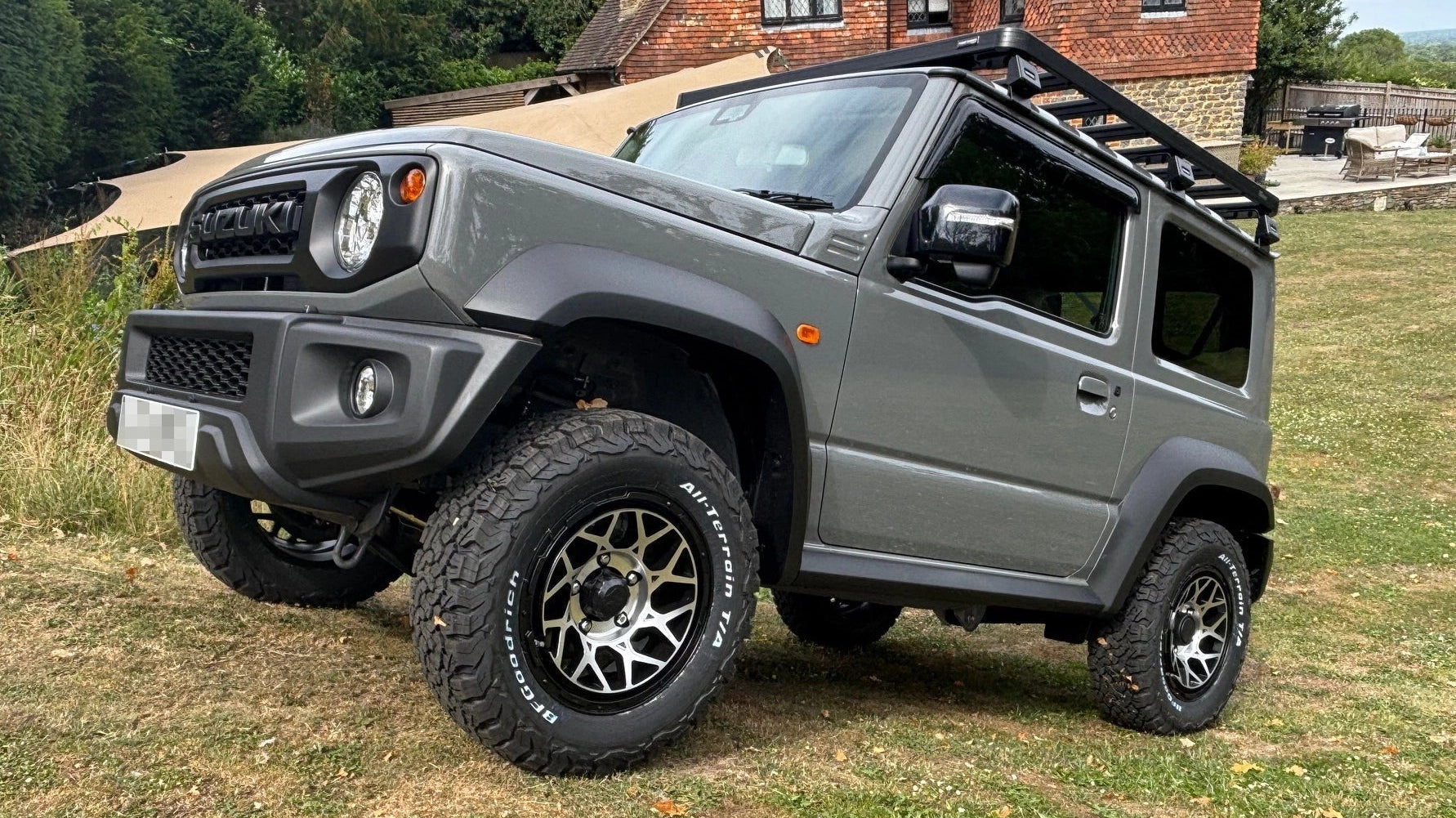 Suzuki Jimny (2018+) with Magpie M-01 wheels in Satin Black with Machined Face and BF Goodrich Tyres, Slimline II Roof Rack and Rear Ladder and Retro Grille with Tactical Badge