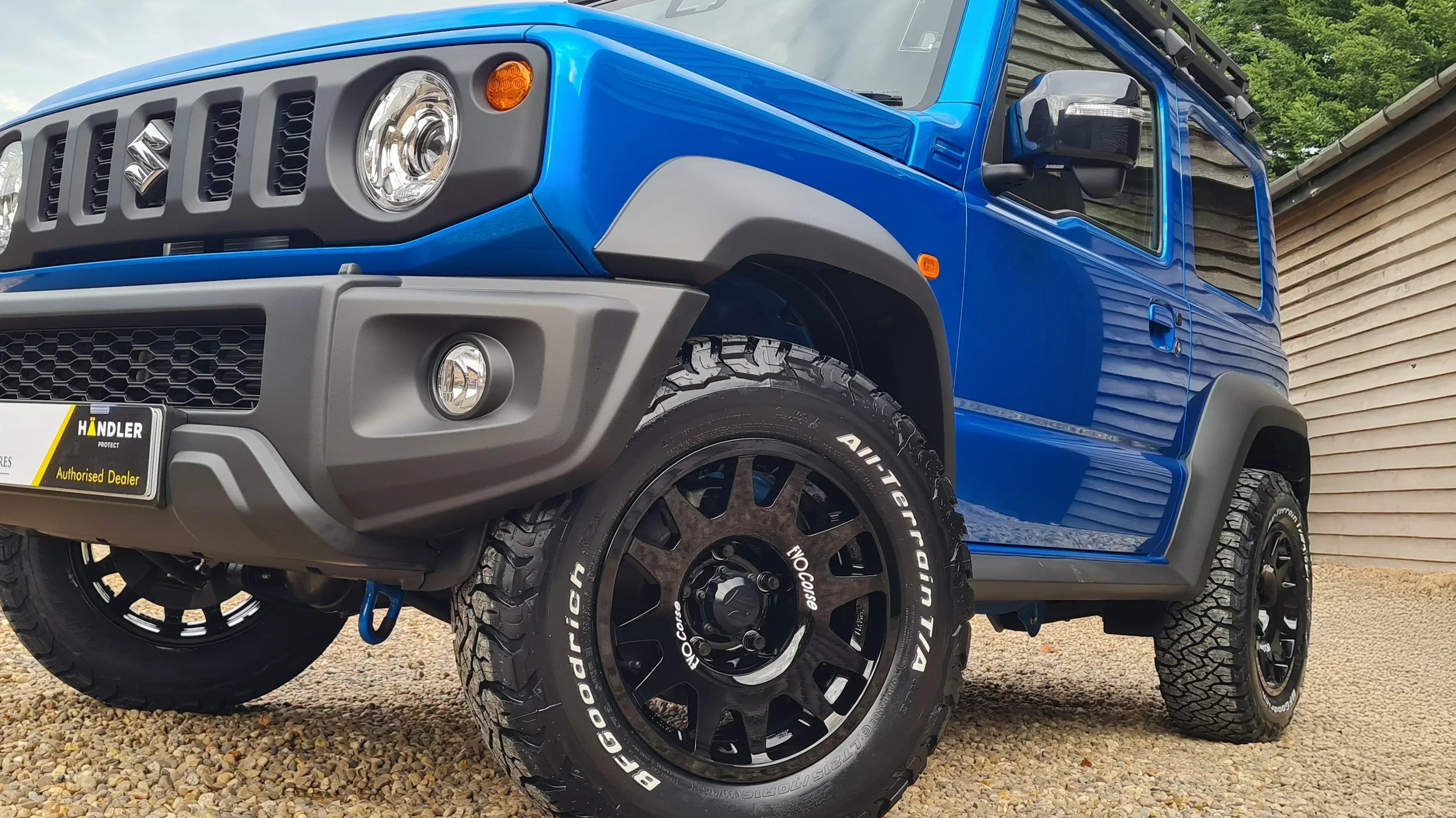 Suzuki Jimny (2018+) with 16" EVO Corse DakarZero wheels in Glossy Black and BF Goodrich KO3 tyres in a 215/70R16 size.