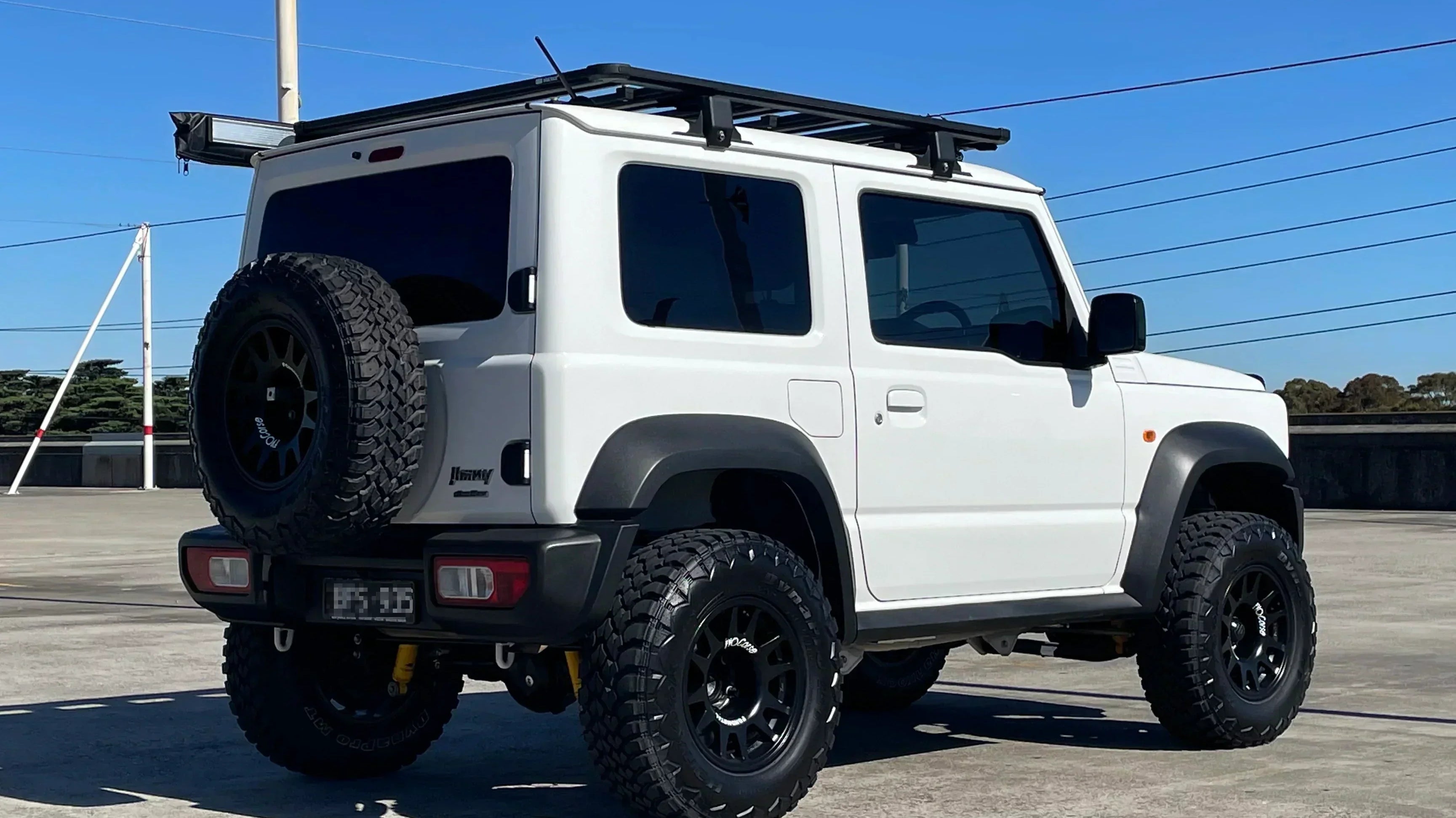 White JB74 Suzuki Jimny fitted with 15" EVO Corse DakarZero wheels