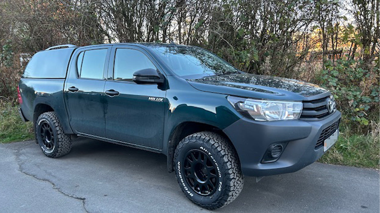 Green Toyota Hilux fitted with Matte Black EVO Corse DakarZero Wheels