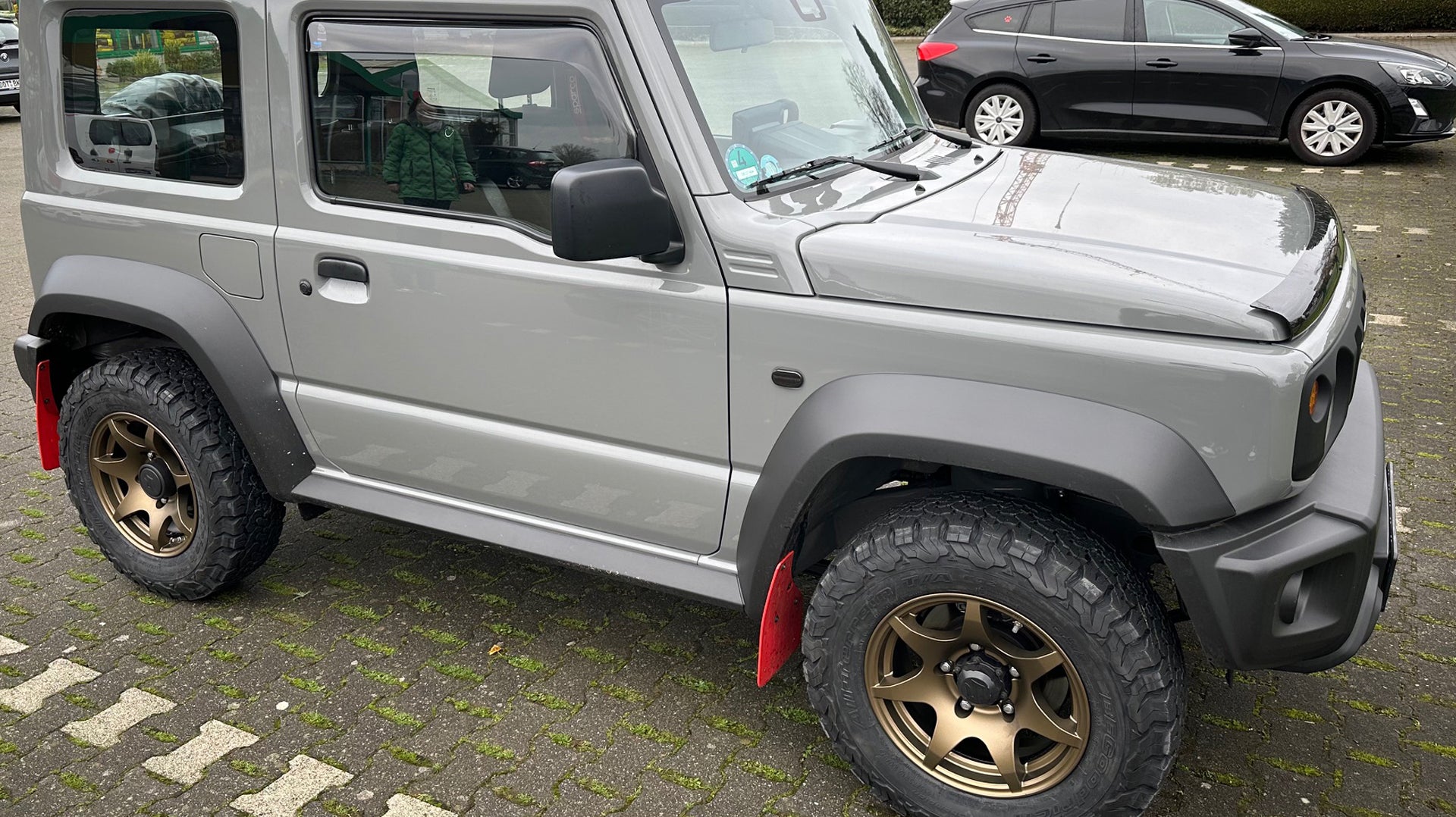 Grey Suzuki Jimny (2018+) fitted with Matte Bronze High Peak J-02 wheels