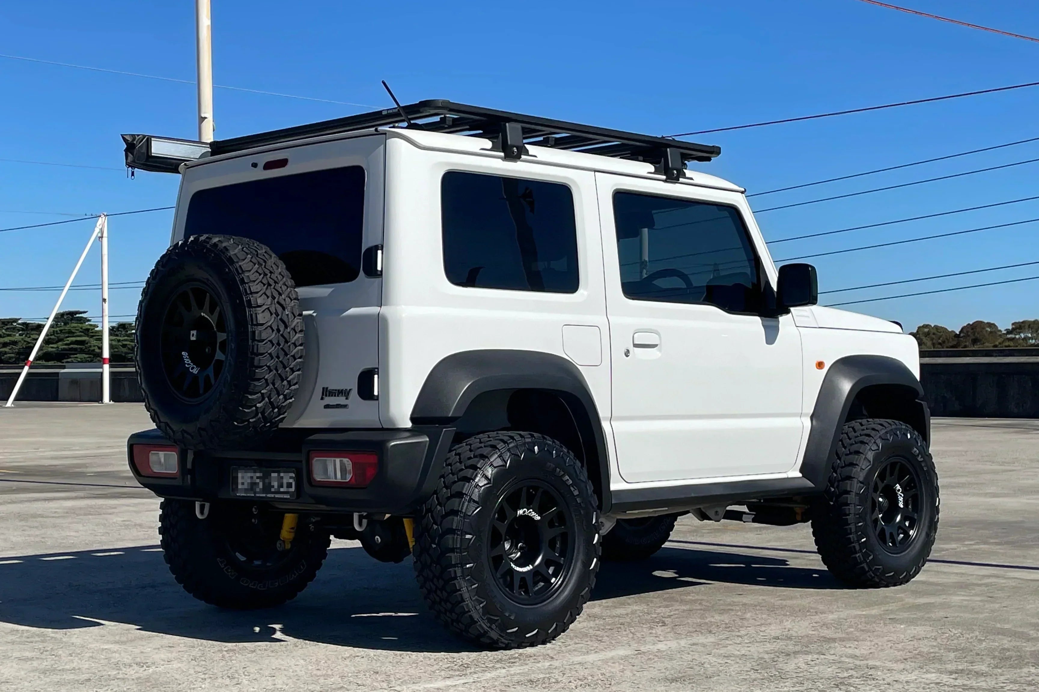 White JB74 Suzuki Jimny fitted with 15" EVO Corse DakarZero wheels
